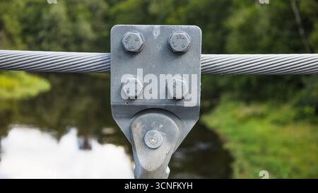 Steel Cable Bolted Connection on Suspension Bridge over River Stock Photo