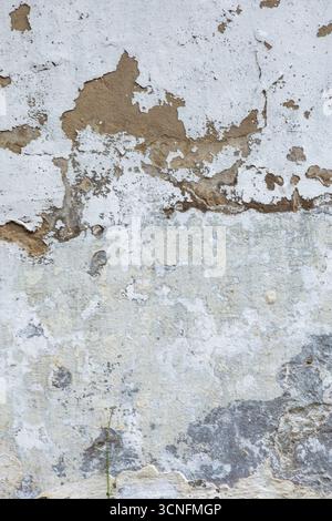 Close-up of old wall with peeling plaster. Natural texture of concrete and plaster under sunlight. High quality photo Stock Photo