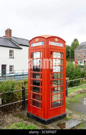 Old redundant public red telephone kiosk used as a community exchange point for seeds and plants with information in both English and Welsh language Stock Photo