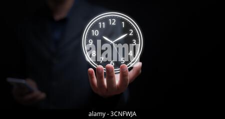 Conceptual image of a man in suit balancing bright clock, representing effective time management, decision making, leadership, business success, and w Stock Photo