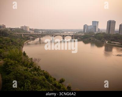 Aerial view of downtown Saskatoon, Saskatchewan, with wildfire smoke hazing the skyline and river valley. Stock Photo