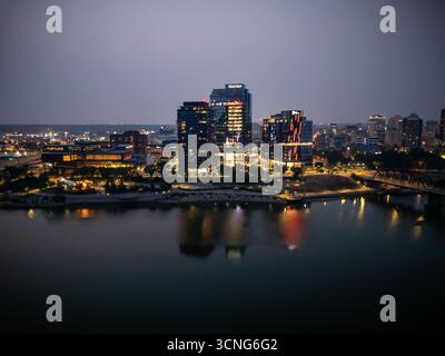 Aerial night view of downtown Saskatoon, Saskatchewan, featuring the city skyline, bridges, and illuminated streets. Stock Photo