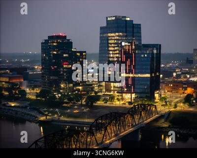 Aerial night view of downtown Saskatoon, Saskatchewan, featuring the city skyline, bridges, and illuminated streets. Stock Photo