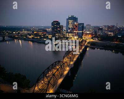 Aerial night view of downtown Saskatoon, Saskatchewan, featuring the city skyline, bridges, and illuminated streets. Stock Photo