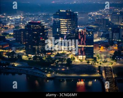 Aerial night view of downtown Saskatoon, Saskatchewan, featuring the city skyline, bridges, and illuminated streets. Stock Photo