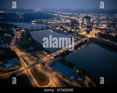 Aerial night view of downtown Saskatoon, Saskatchewan, featuring the city skyline, bridges, and illuminated streets. Stock Photo