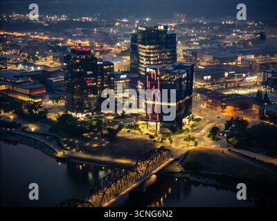 Aerial night view of downtown Saskatoon, Saskatchewan, featuring the city skyline, bridges, and illuminated streets. Stock Photo