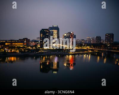 Aerial night view of downtown Saskatoon, Saskatchewan, featuring the city skyline, bridges, and illuminated streets. Stock Photo