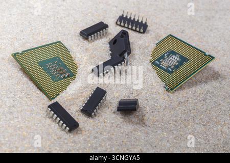 Radio-electronic components, microcircuits, transistors, central processors on pure quartz sand, from which semiconductors are made. Stock Photo