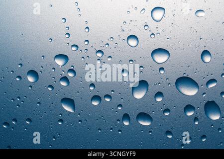 Water drops on a rough surface. Macro photography. Stock Photo