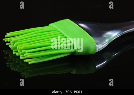 Silicone kitchen brush on a black background. Stock Photo