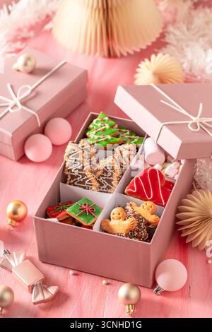 Tasty Christmas gingerbread cookies in rose gift box.. Cozy winter composition with treats. Stock Photo