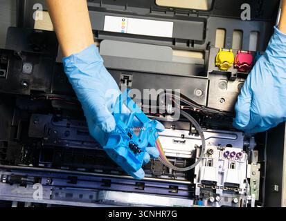 Top view of technician repairing and using printer repair tools. Stock Photo