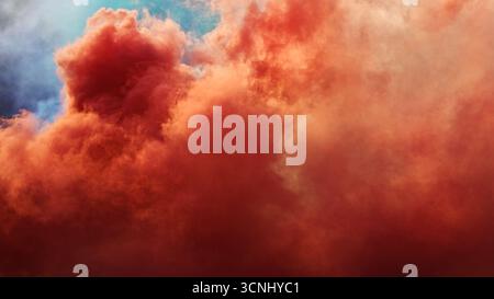Dense red smoke drifting through air, festive abstract composition. Selective focus. Stock Photo
