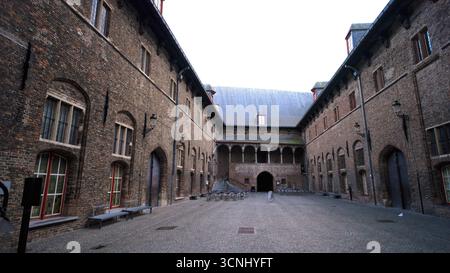 BRUGES, BELGIUM - SEPTEMBER 15, 2025 - Bruges Beguinage courtyard presenting historic brick buildings with arches and cobblestone pavement Stock Photo