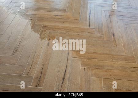 Modern herringbone floor tiles being impregnated Stock Photo