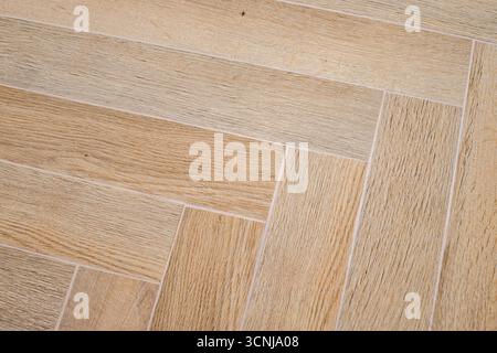 Herringbone floor with rectangular tiles arranged in broken zigzags Stock Photo