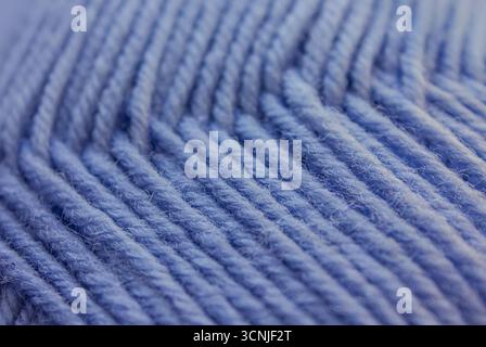 Close-up Blue Wool knitted Texture background. Blue Yarn threads abstract background. Blue knitting yarn textured backdrop. Stock Photo