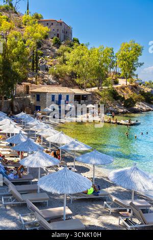 Parasols at Mandraki Taverna Beach, Mandraki, Hydra Island, Saronic Islands, Greece Stock Photo