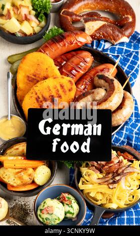 Various austrian dishes- schnitzel, sausages, potatoes, Knodel, salad and sauces on a light background. Top view. Stock Photo