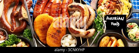Various austrian dishes- schnitzel, sausages, potatoes, Knodel, salad and sauces on a light background. Top view. Panorama. Stock Photo