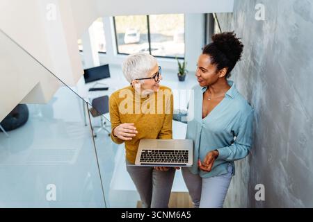Mixed team of software engineers brainstorming ideas. Diverse app developers collaborating as group Stock Photo