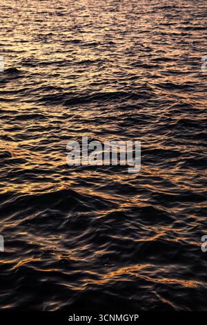 Orange sunset over the sea. Water surface Stock Photo