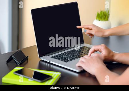 Person working on laptop in modern workspace Stock Photo