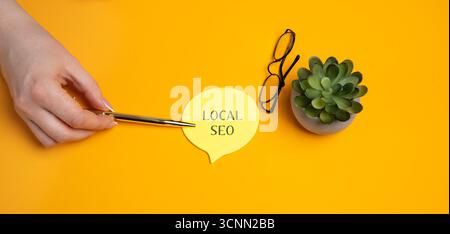 Local SEO, Search Engine Optimization. Process of optimizing a website or online presence to improve its visibility in local search results. A woman's Stock Photo