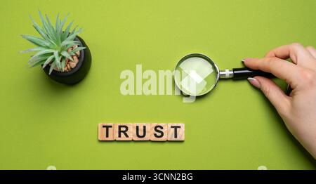 Wooden blocks with the word Trust. Trust relationships between business partners, friends, relatives. Respect and authority. Confidence in a person. R Stock Photo