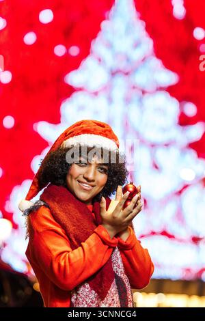 Transgender woman celebrating christmas with festive ornament Stock Photo