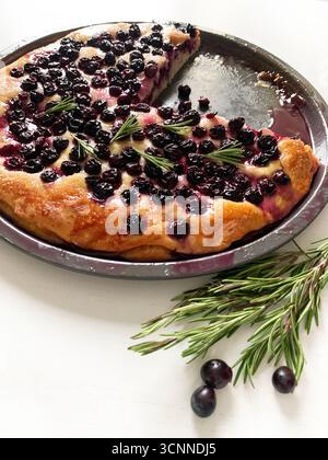 Traditional tuscan dessert. Homemade "Schiacciata all'uva", typical Tuscan sweet focaccia with black grapes isolated on white wooden table. Stock Photo