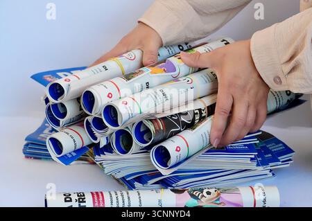 Unidentified businesswoman stacks of newspapers. Stock Photo