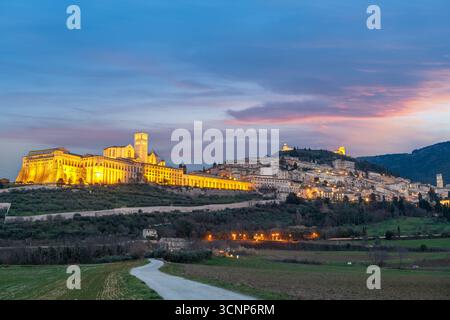 Assisi, Italy town skyline with the Basilica of Saint Francis of Assisi at dusk. Stock Photo