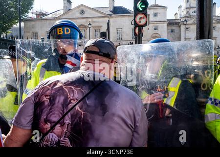 Metropolitan Police Officers Stand Behind Riot Shields Preventing ...