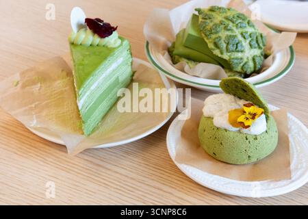 Green Tea Desserts on Wooden Table - West Lake in Huizhou, Guangdong Province, China, is a tourist attraction featuring ancient architecture Stock Photo