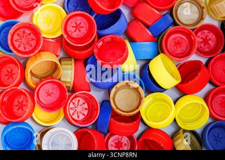 Multicolored bottle caps close-up for recycling concept. Recycling background made of plastic caps. Stock Photo