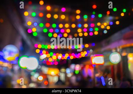 Blurred colorful colored circles, night view overhead light decoration street  taken out of focus for use as a colourful background. Stock Photo