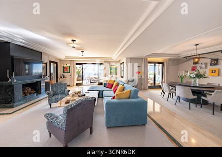 Luxurious open-plan living and dining room with sea view in mediterranean penthouse Stock Photo
