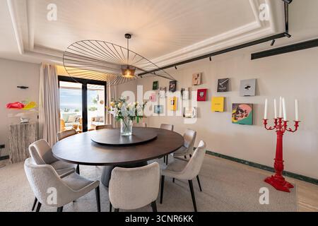 Modern and Elegant Dining Room Interior with Round Table and Unique Decor in mediterranean penthouse Stock Photo