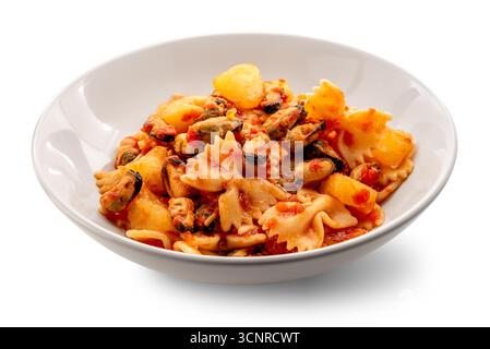 Bowtie pasta with mussels and potatoes in tomato sauce on a white plate isolated on white with clipping path included Stock Photo