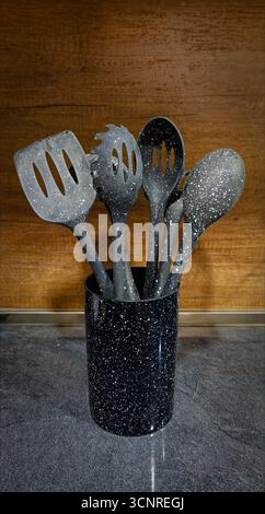 Used black with white dots plastic kitchen utensils Stock Photo