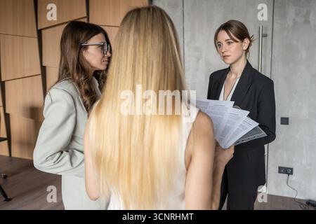 Team employees preparing for a briefing Stock Photo
