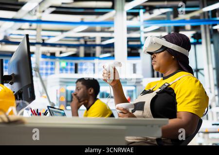 Photovoltaics facility engineer using VR tech to build generators for solar cells to produce renewable energy. Industrial plant employee creates solar panel using virtual reality gear. Stock Photo
