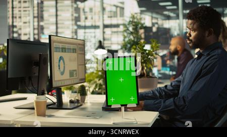 Close up of isolated screen tablet used by worker in office reviewing financial graphs. Employee looking over data trends and strategic insights on mockup tablet, analyzing KPIs, camera B Stock Photo