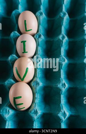 live written in Fresh, organic eggs, both white and brown, are packaged in a cardboard container. Stock Photo