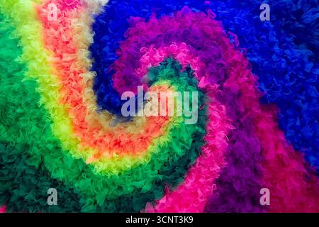 Colorful multi-colored spiral pattern of the rainbow made of fabric. Backgrounds Stock Photo