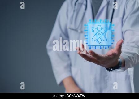 Doctor in lab coat presenting a futuristic digital chip with atom icon, symbolizing innovation in medical technology, healthcare AI, and quantum compu Stock Photo