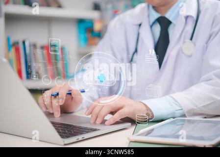 Doctor working on laptop with virtual cloud icons and healthcare data, cloud computing in the future of medical information management.digital transfo Stock Photo