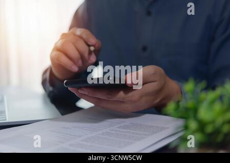 Business communication on smartphone: User checking data or messages, emphasizing mobile banking, secure transactions, and portable office capabilitie Stock Photo